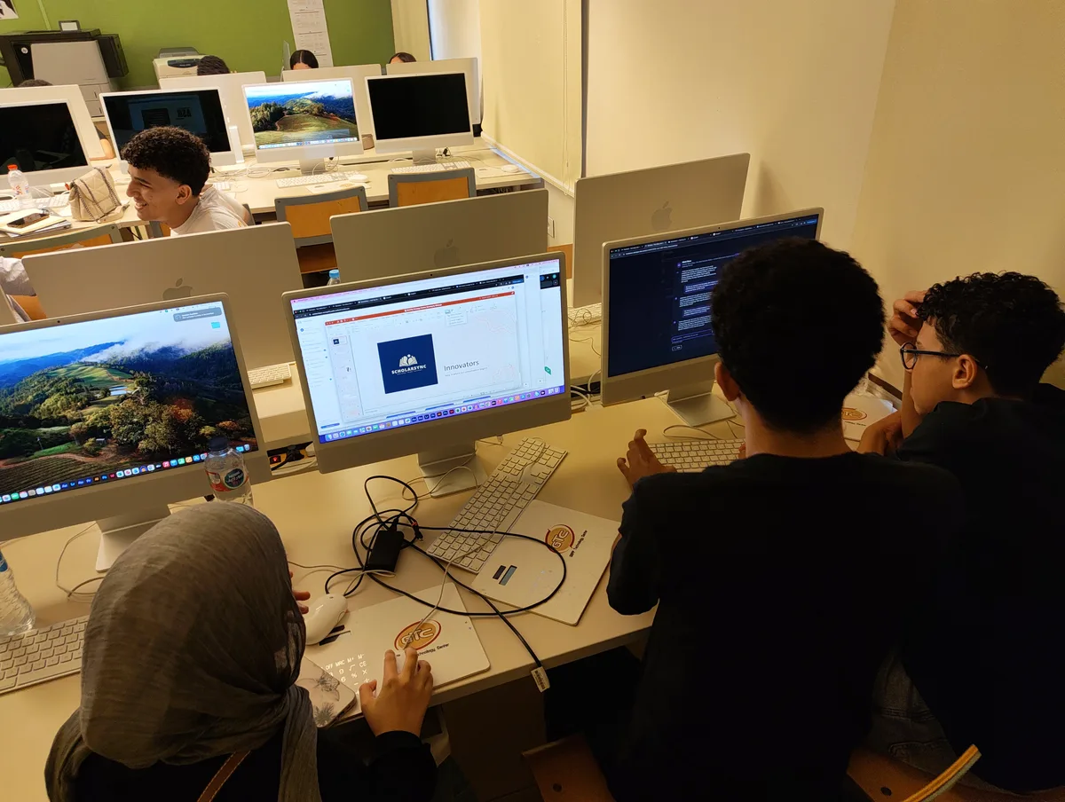 Young founders working together on laptops at the Startopia AUC Bootcamp build day