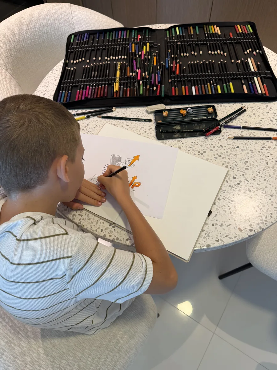 A child designing their company logo at home as part of the GEMS Family First founder challenge