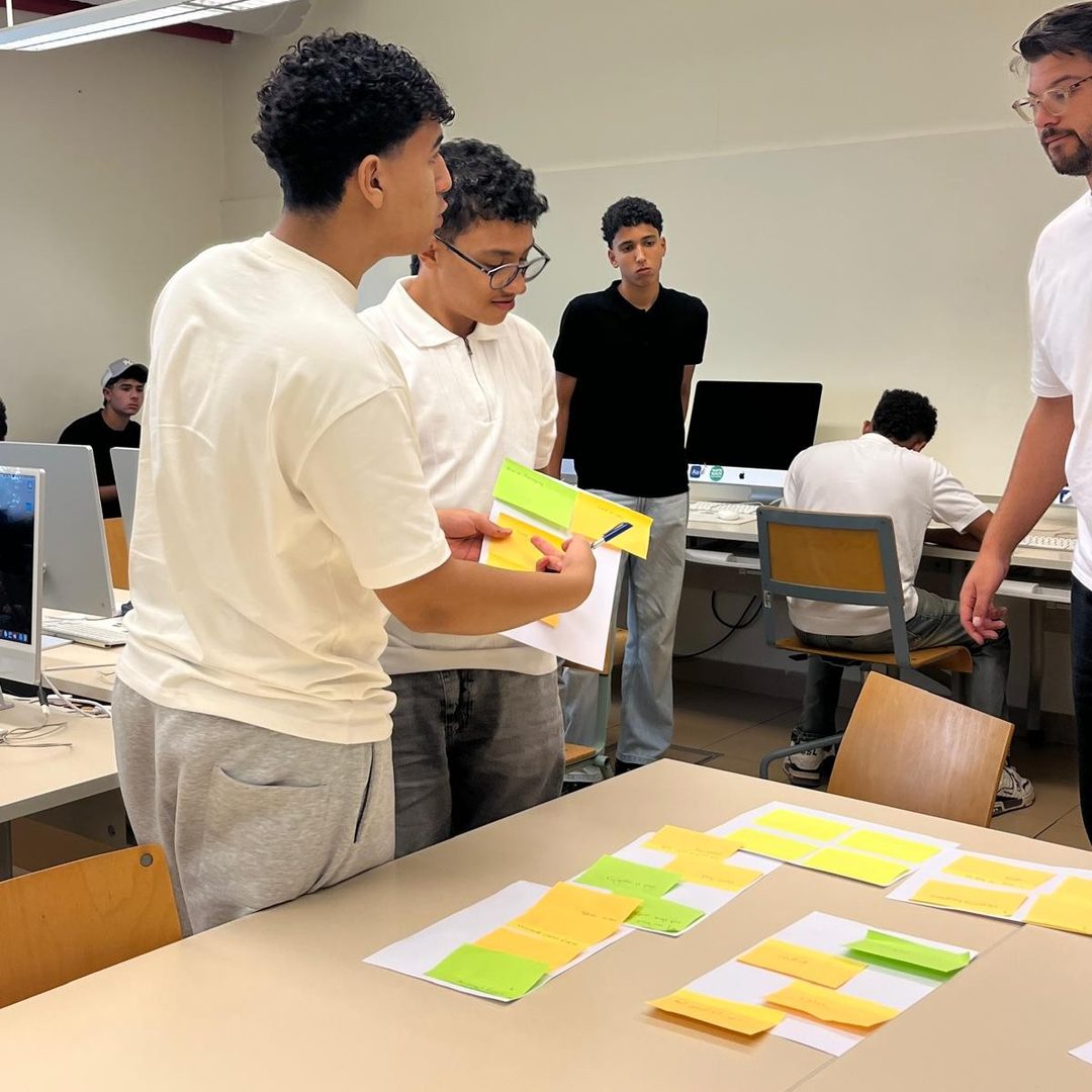 Students presenting their problem notes to a coach