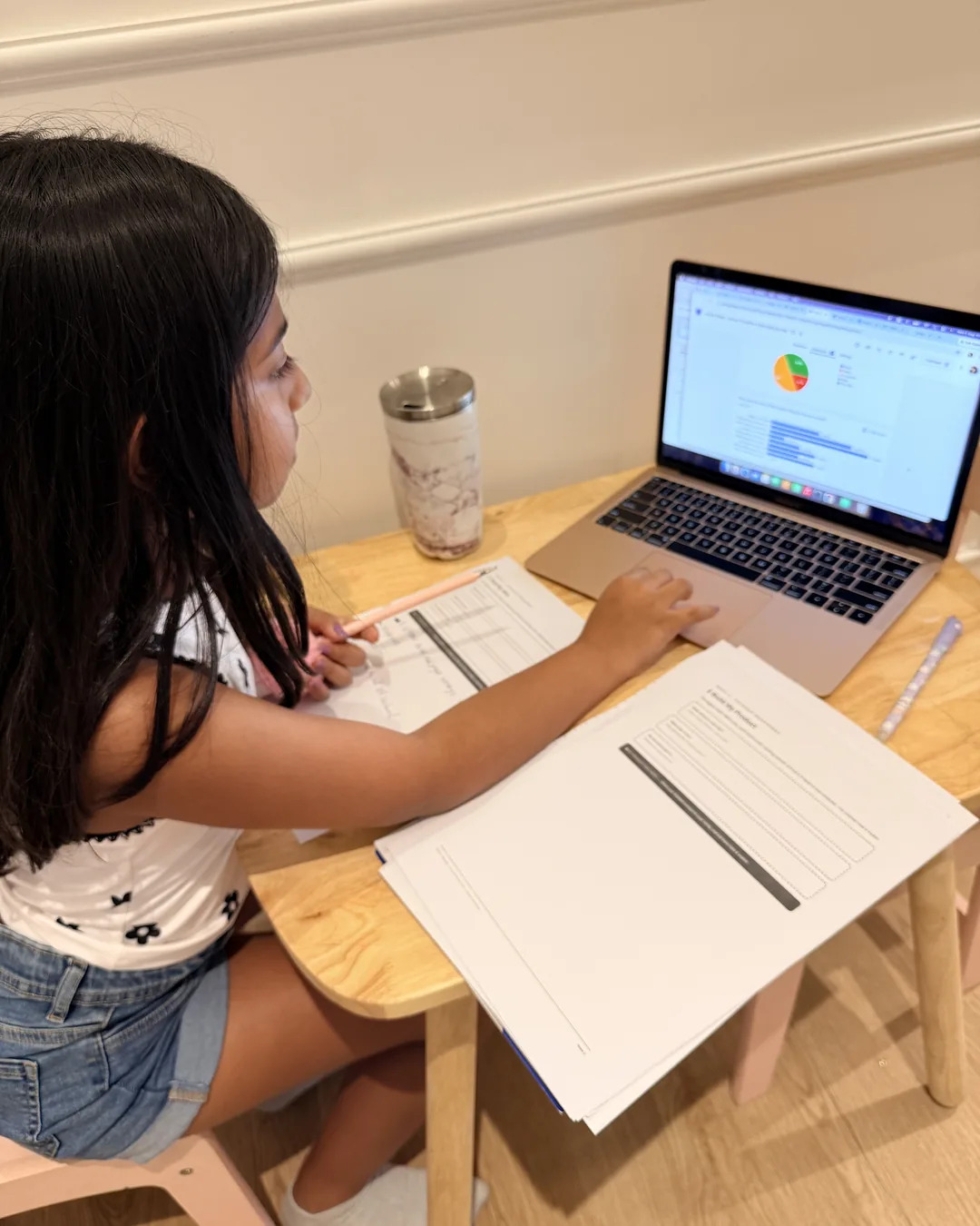 A young founder reviewing her survey results on a laptop